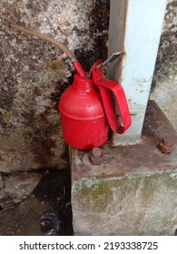 Red Oil Gun Near The Wall Of The House