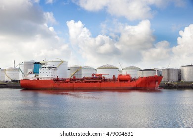 Red oil tanker moored at an oil terminal in a port