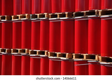 Red oildrums on wooden pallets in an industrial storage