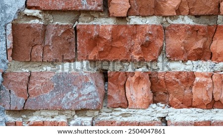 red old brick wall background, brick wall texture, structure. old broken brick, cement joints, close-up. crumbling from old age. macro photo. construction, repair. concept of devastation, decline