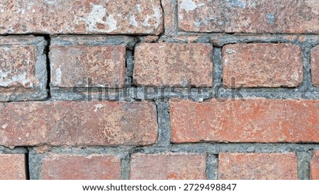 red old brick wall background, brick wall texture, structure. old broken brick, cement joints, close-up. crumbling from old age. macro photo. construction, repair. concept of devastation, decline