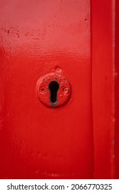 Red Old Lock Key Hole In Wooden Door Painted Bright Retro Historic Red.