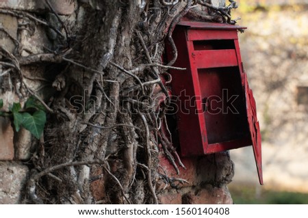 Red old mailbox on the wall. Letter boxes