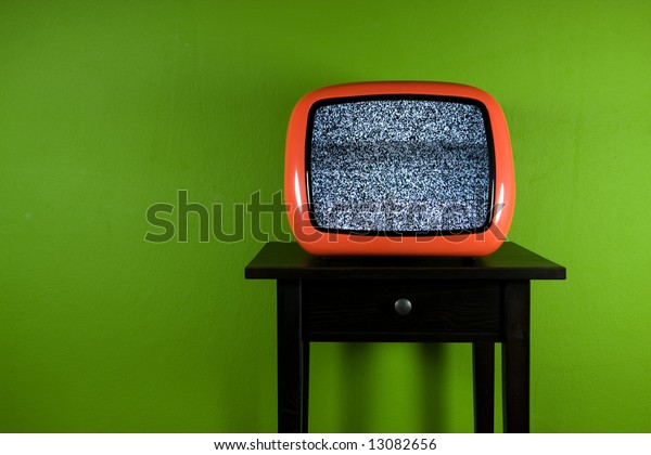 Red old retro\
television on green room