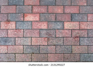 Red old stone pavement with abstract pattern closeup. crumble with age. construction, repair. concept of destruction, decline. High quality photo