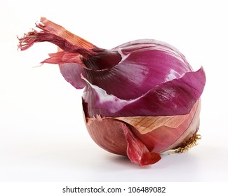 Red onion layers (allium) One red onion with underlying layers visible. Isolated on white background.