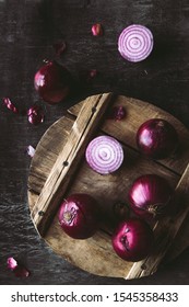 Red Onion Slices On Wooden Board With Dark Background