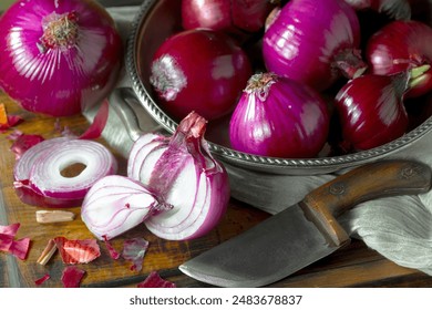 Red onion, whole and cut into slices in a kitchen bowl on the table. - Powered by Shutterstock