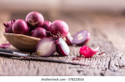 Red onions on very old oak wooden board. 