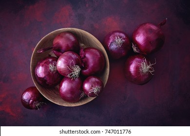 Red onions in a wooden bowl. Food Ingredients. 