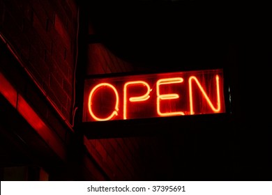 Red open neon sign glowing in the night - Powered by Shutterstock