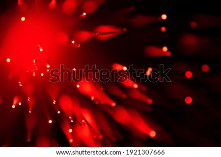 red optical fibre in dark selective focus and kinda looks like coronavirus