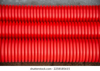 Red orange insulation in the form of plastic corrugated pipes. View from above. - Shutterstock ID 2258185615