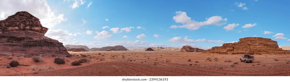 Red orange landscape in Jordan Wadi Rum desert, mountains background, small off road vehicle on side - Powered by Shutterstock