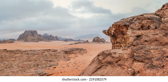 Red orange Mars like landscape in Jordan Wadi Rum desert, mountains background, overcast morning. This location was used as set for many science fiction movies - Powered by Shutterstock