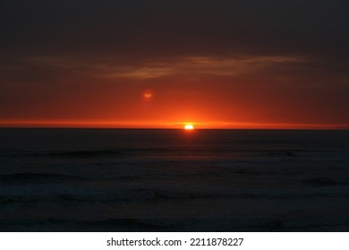 Red Orange Sunset Over A Dark Ocean