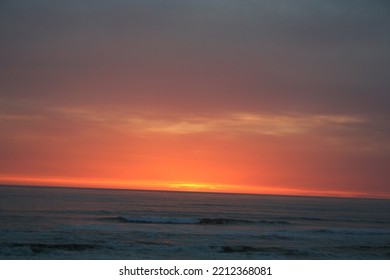 Red Orange Sunset Over A Dark Ocean