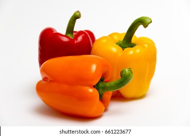 Red, Orange And Yellow Bell Peppers Isolated On White