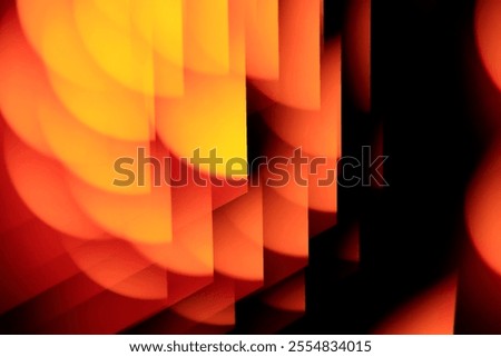 Red, orange and yellow pattern on a black background. Semi circle gradient fractal pattern. A photo of a light burst reflected and refracted through prism glass. Graphic design resource background.