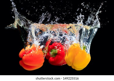 Red, orange and yellow peppers splashing water - Shutterstock ID 149225516