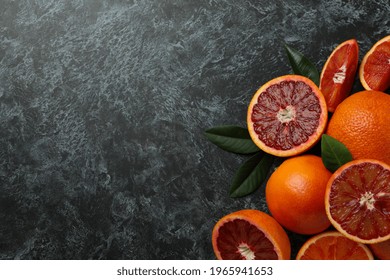 Red Oranges And Leaves On Black Smoky Background