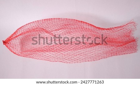 Red packaging net or mesh packaging for fruits and vegetables on white background. 