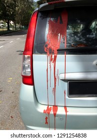 Red Paint Being Splash On A Car. It Is A Tactic Used By Loan Sharks In Asia When Rental Money Is Not Paid On Time