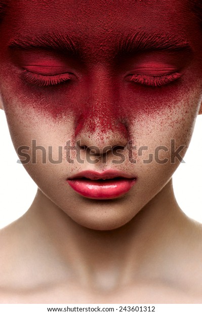 Red paint on face of fashion beauty model