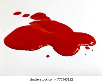 Red Paint Spill On The White Background