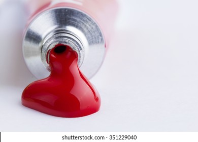 Red paint spill from tempera on white background - Shutterstock ID 351229040