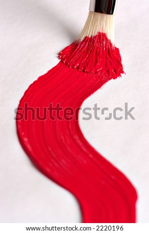 Red paint stroke on canvas