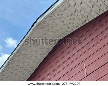 Red painted siding wall texture on home exterior highlighting residential construction material and design detail