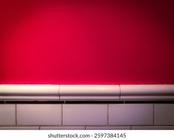 Red painted wall with ceramic tile base