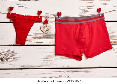 Red Panties And Boxer Briefs. Underwear On Rope With Clothespins. Red Color As Love Symbol.