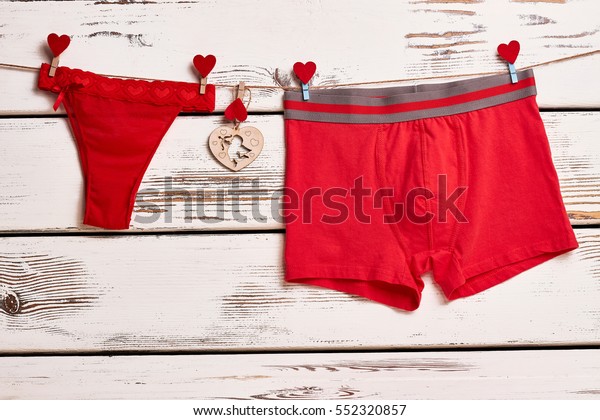 Red panties and boxer briefs.\
Underwear on rope with clothespins. Red color as love\
symbol.
