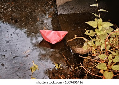 Red Paper Boat In The Ditch. Abstract Autumn Theme Image