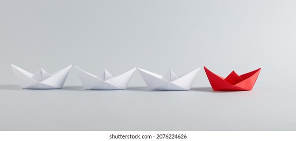 Red Paper Boat Leads White Paper Ships. Leadership, Collaboration, Cooperation, Or Partnership In Business Concept.