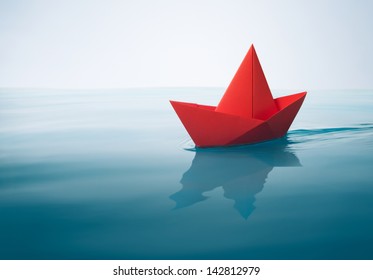 Red Paper Boat Sailing On Water With Waves And Ripples