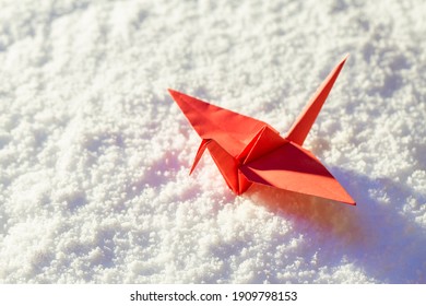 Red Paper Crane On Sunny Day And Snow