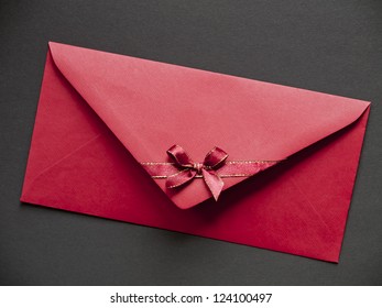 Red paper envelope with bow