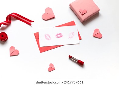 Red paper envelope with white blanks with lipstick kisses and pink origami hearts. Valentine's day concept card. - Powered by Shutterstock