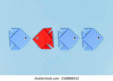 Red Paper Fish Swimming Swimming Against The Current In Opposite Direction Of Blue Fish