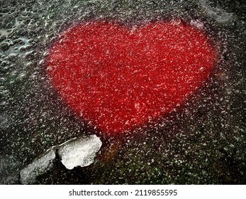 Red Paper Heart Trapped Under Ice.