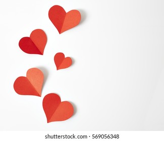 Red paper hearts isolated on white background - Shutterstock ID 569056348