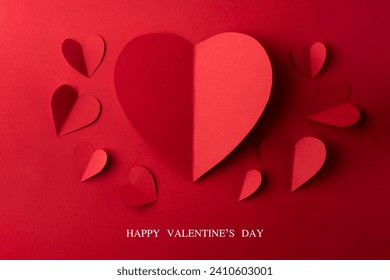 Red paper hearts on red background, Valentines day card.
