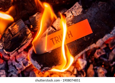 Red paper with inscription Truth burning in the fire. Hiding truth, telling a lie symbol