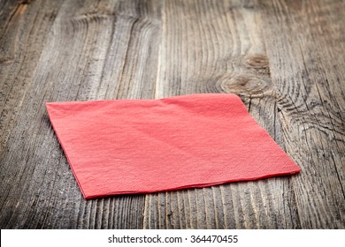 Red Paper Napkin On Wooden Table