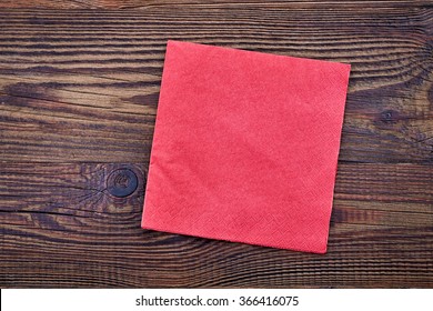 Red Paper Napkin On Wooden Table, Top View