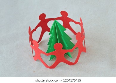 Red Paper People In A Circle Around A Tree On Recycled Paper Background - Ecology Concept