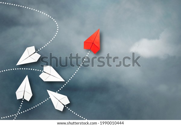 Red paper\
plane flying in a different direction than the white ones. Cloudy\
sky. Copy space. The concept of innovative solutions, creativity.\
Business. Lifestyle.\
Background.